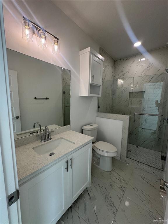 11403 North 24th Lane, Unit 1 McAllen, TX 78504 - Photo 12 of 13 a bathroom with a toilet sink and mirror