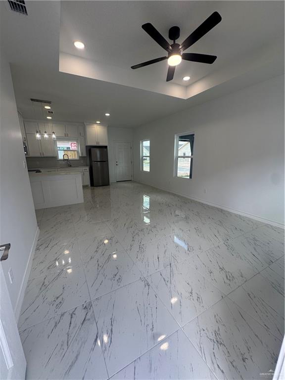 11403 North 24th Lane, Unit 1 McAllen, TX 78504 - Photo 2 of 13 a view of a livingroom with a ceiling fan and window