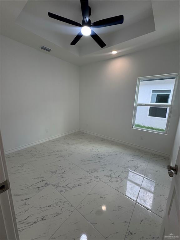 11403 North 24th Lane, Unit 1 McAllen, TX 78504 - Photo 5 of 13 an empty room with windows and fan