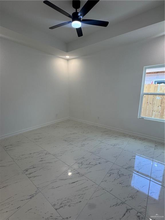 11403 North 24th Lane, Unit 1 McAllen, TX 78504 - Photo 7 of 13 an empty room with a ceiling fan and window