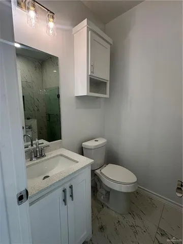 a bathroom with a sink a toilet and mirror