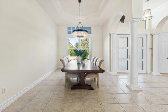 a living room with furniture a flat screen tv and a large window