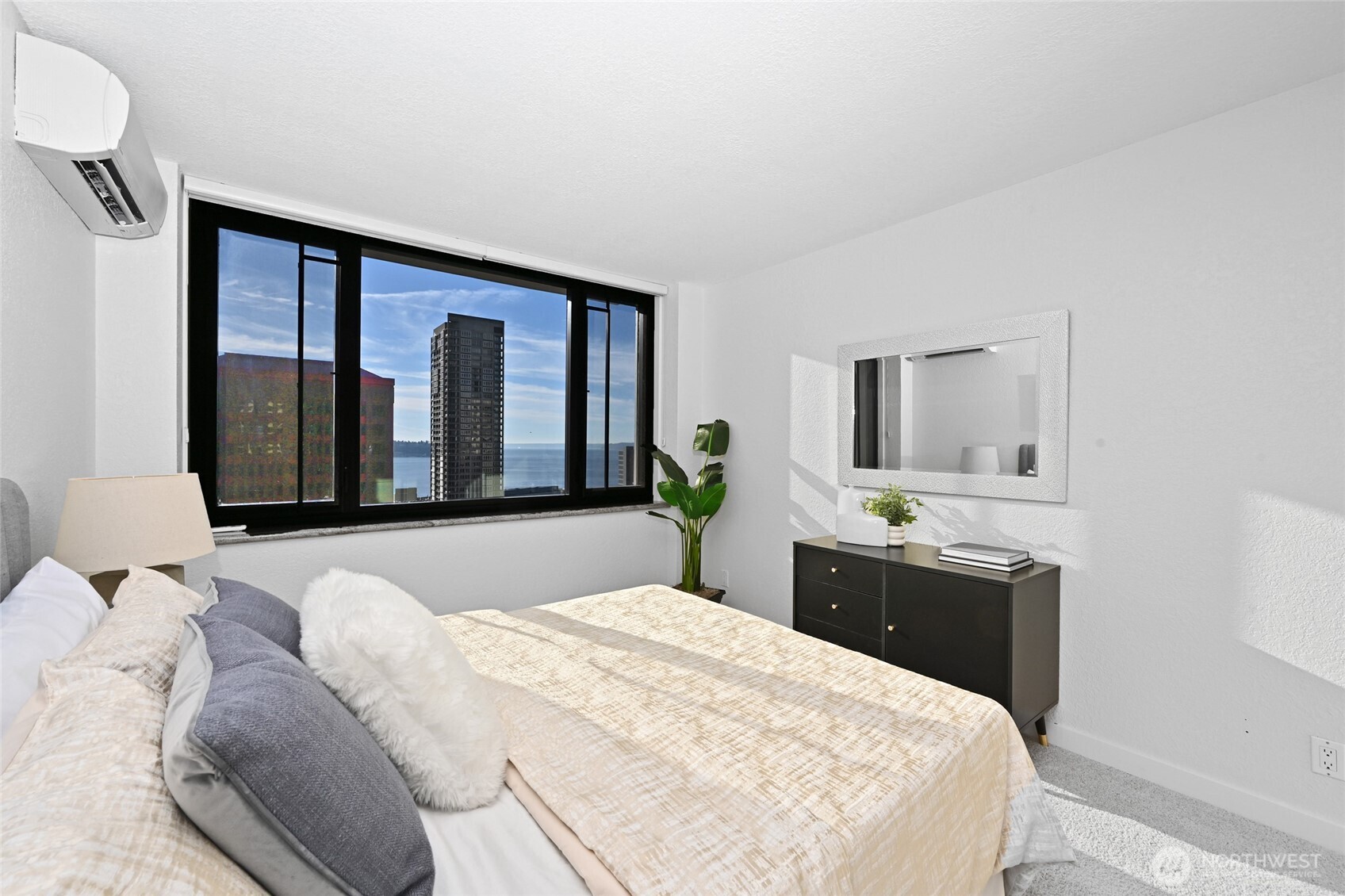 2100 3rd Avenue, Unit 1502 Seattle, WA 98121 - Photo 11 of 31 a bedroom with a large bed and a flat tv screen on dresser