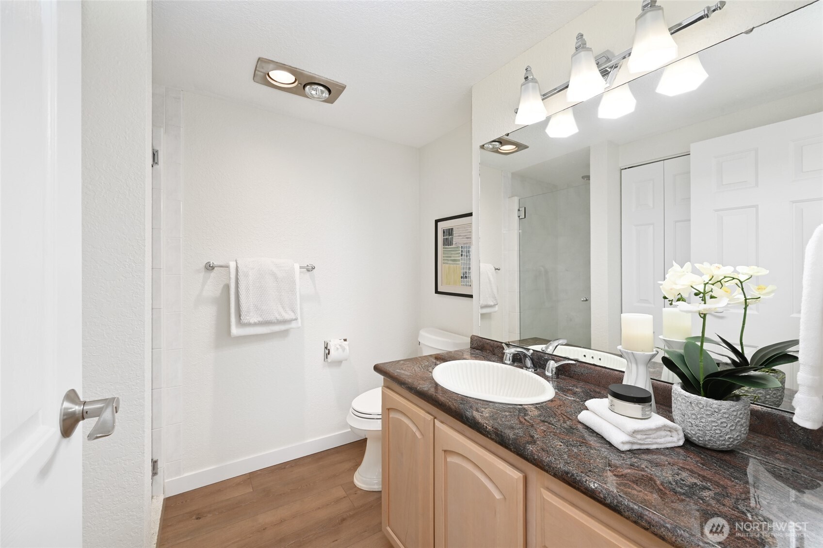 2100 3rd Avenue, Unit 1502 Seattle, WA 98121 - Photo 12 of 31 a bathroom with a granite countertop sink a large mirror and a potted plant