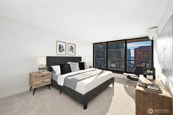 a bedroom with a bed and a large window