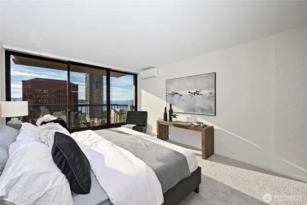 a large bedroom with a bed and large window