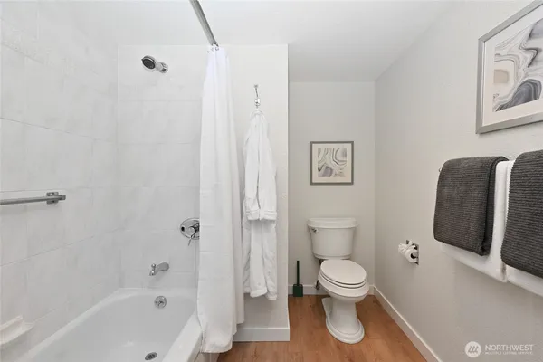 a bathroom with a toilet and a shower