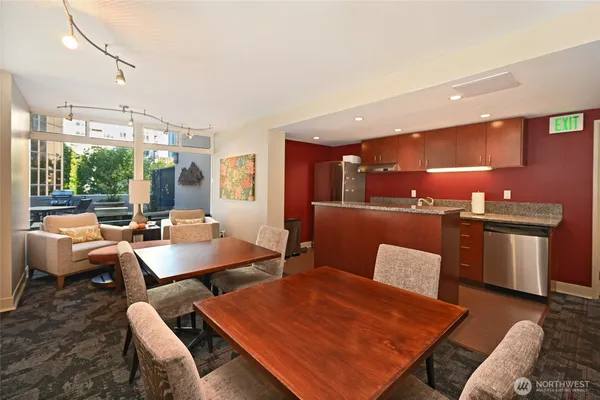 a living room with furniture a large window with kitchen view