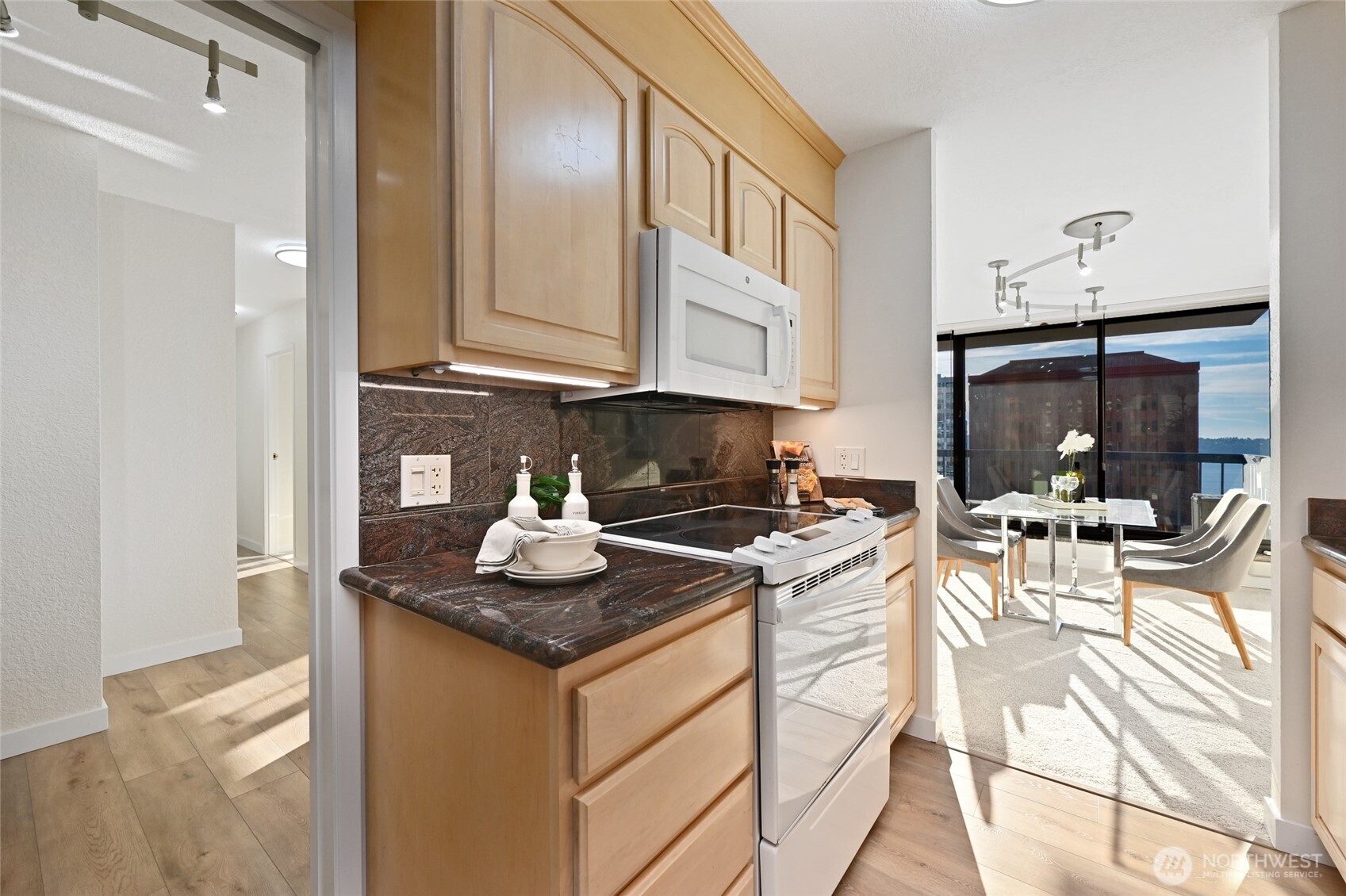 2100 3rd Avenue, Unit 1502 Seattle, WA 98121 - Photo 8 of 31 a kitchen with stainless steel appliances granite countertop a stove and a sink
