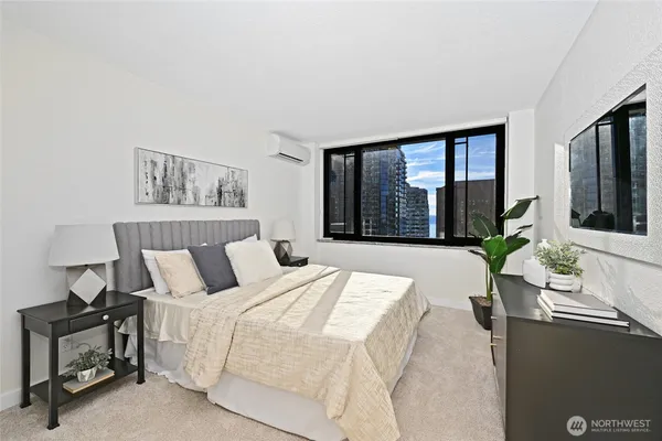 a bedroom with a large bed and a large window