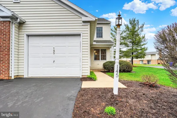a view of a house with a yard and garage