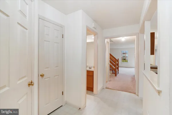 a view of a hallway with a furniture and a refrigerator