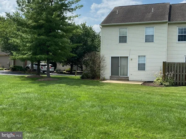 a view of a backyard with large trees