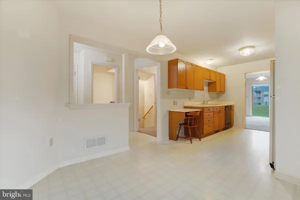 a view of a kitchen with a sink and cabinets