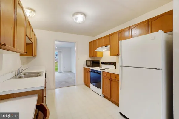 a kitchen with stainless steel appliances a refrigerator sink and stove