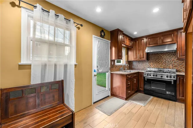 a kitchen with stainless steel appliances granite countertop a stove and a refrigerator