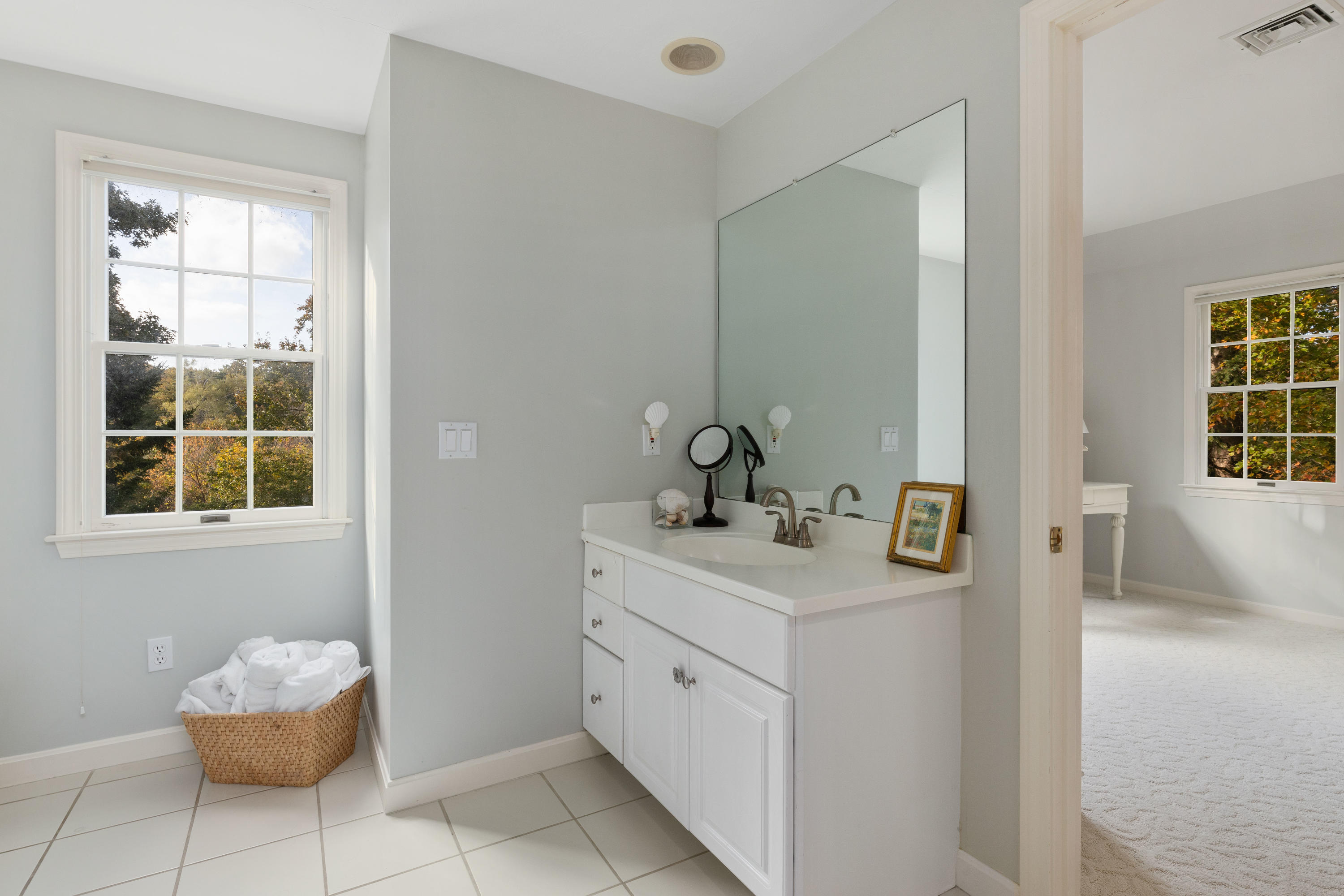 461 South Main Street Centerville, MA 02632 - Photo 31 of 52 a spacious bathroom with a granite countertop sink and a mirror