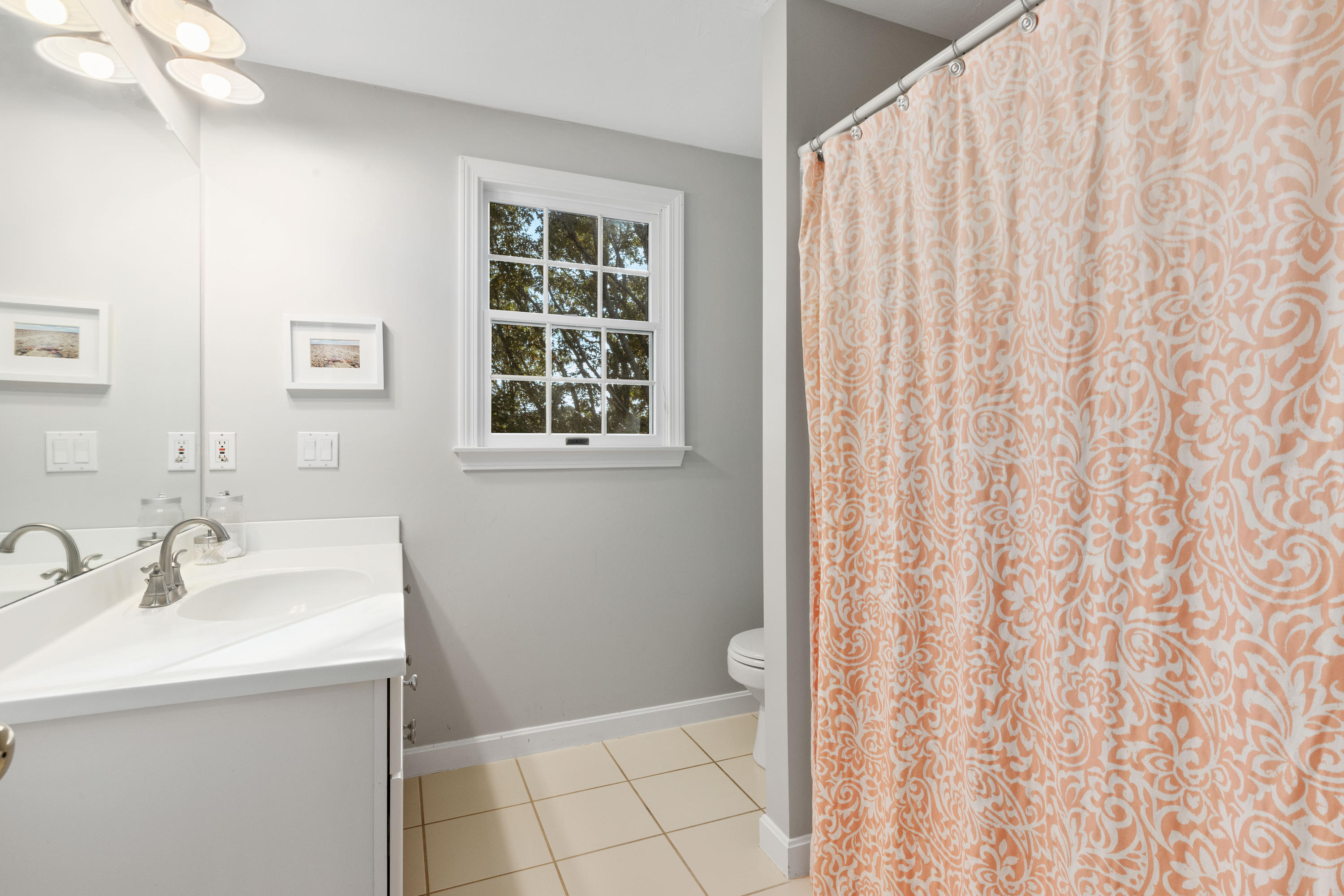 461 South Main Street Centerville, MA 02632 - Photo 36 of 52 a bathroom with a sink a vanity and a shower