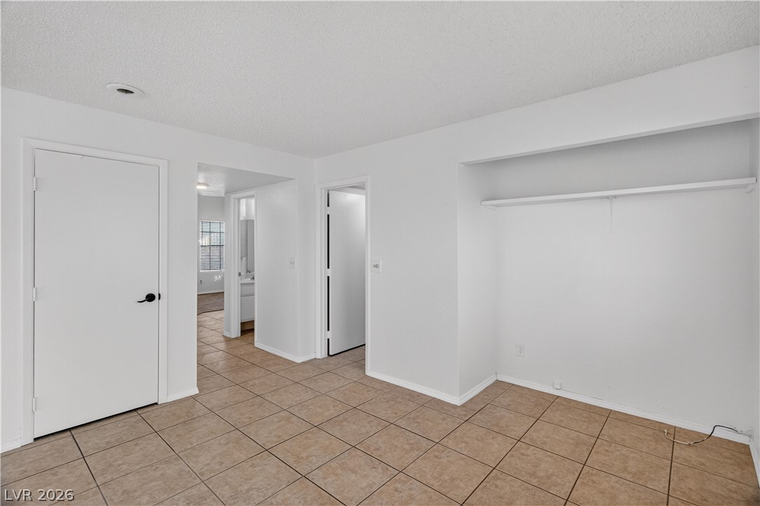 3156 Terrace View Drive Laughlin, NV 89029 - Photo 24 of 94 Functional bedroom featuring tile flooring and an open closet space.