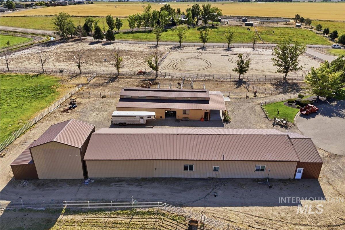 20337 Maggard Lane Caldwell, ID 83607 - Photo 38 of 50 This is the back side of the shop, bunkhouse, craft studio, 3-bay equipment storage with roll-up doors, 24T hay barn and additional storage. In the background is the barn.