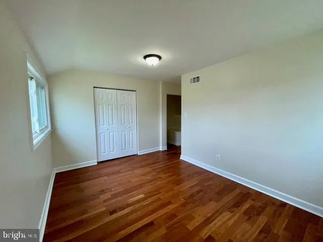 a view of room with wooden floor