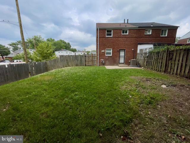 2301 Wyngate Road Suitland, MD 20746 - Photo 16 of 16 a view of a house with brick walls and a yard with wooden fence