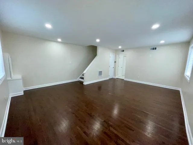 an empty room with wooden floor