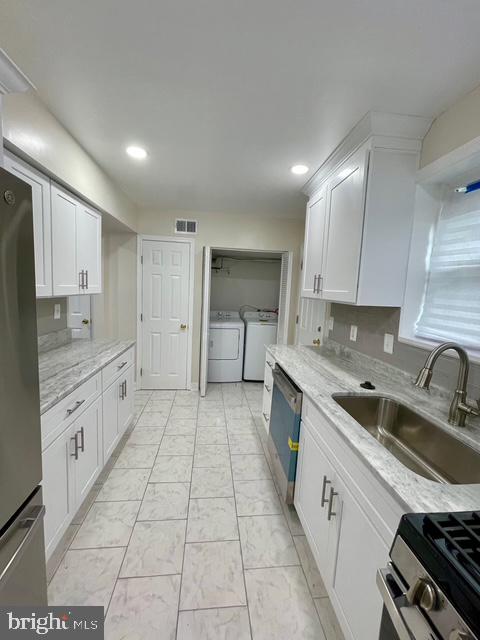 2301 Wyngate Road Suitland, MD 20746 - Photo 9 of 16 a large kitchen with a stove sink and cabinets
