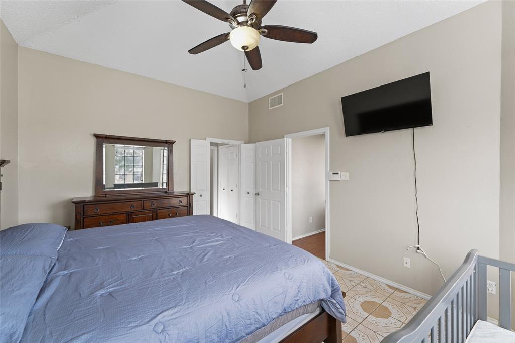 708 Azalea Drive Forney, TX 75126 - Photo 11 of 18 a bedroom with a bed and a flat screen tv