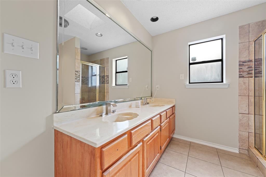 708 Azalea Drive Forney, TX 75126 - Photo 13 of 18 a bathroom with a sink and a mirror