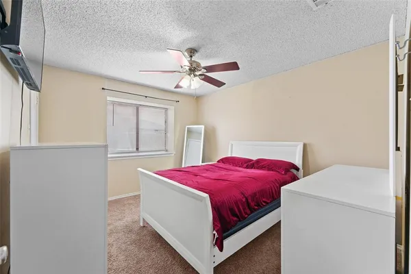 a bedroom with a bed and a tv