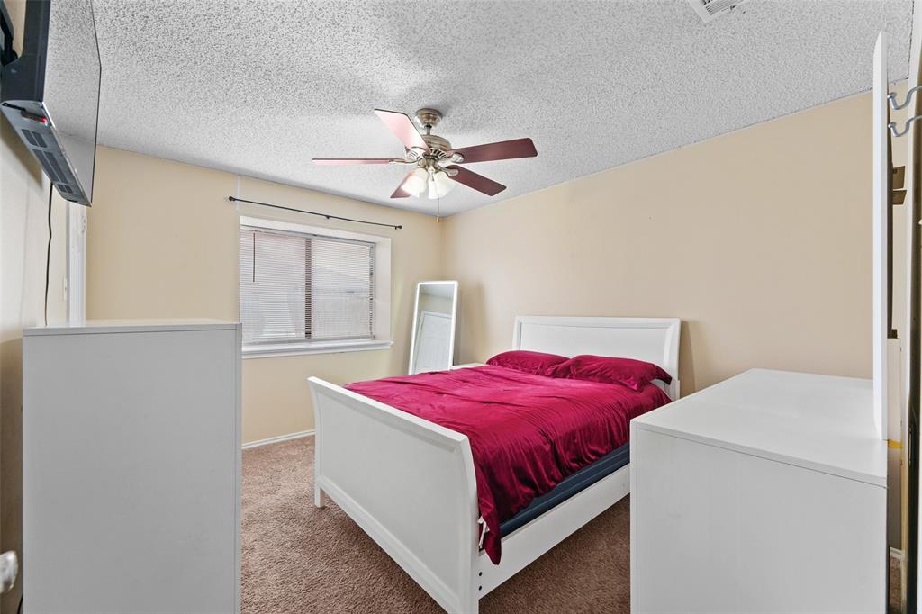 708 Azalea Drive Forney, TX 75126 - Photo 14 of 18 a bedroom with a bed and window