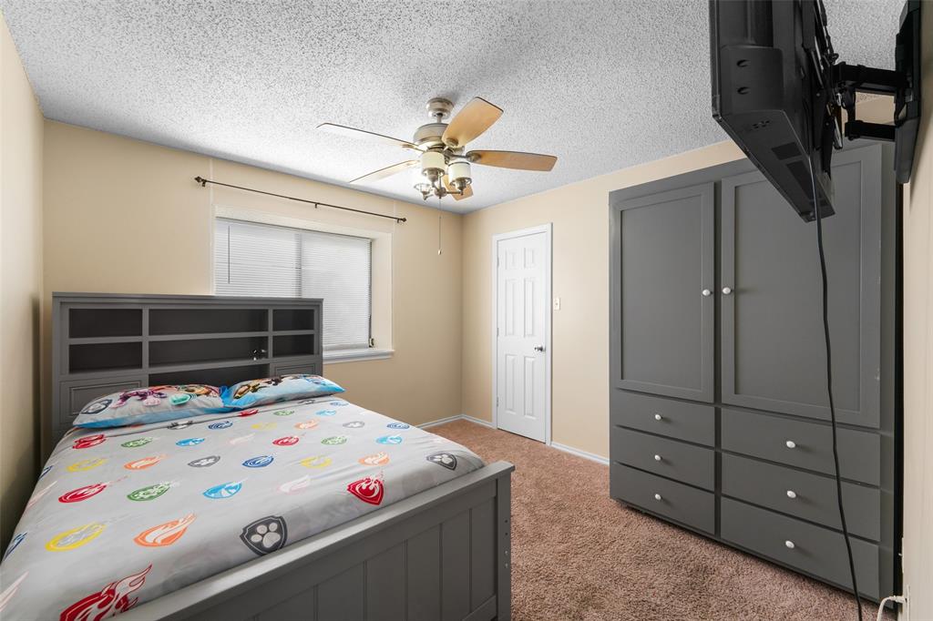 708 Azalea Drive Forney, TX 75126 - Photo 15 of 18 a bedroom with a bed and a tv