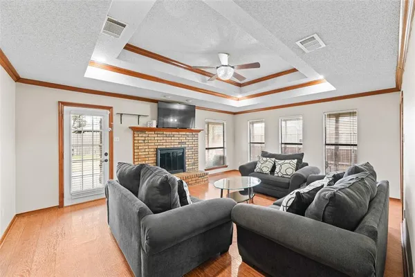 a living room with furniture a fireplace and a large window