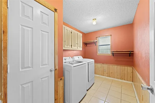 a dining room with furniture potted plants and wooden floor