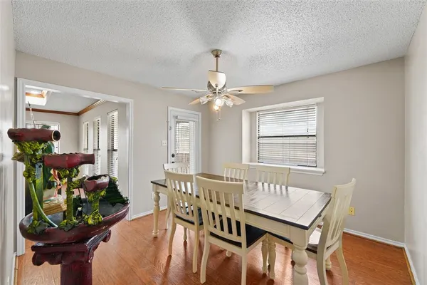 a view of an empty room with cabinet and a chandelier fan