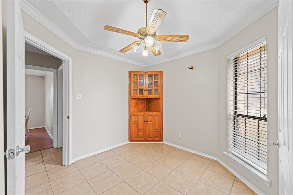 708 Azalea Drive Forney, TX 75126 - Photo 7 of 18 a view of an empty room with cabinet and a chandelier fan