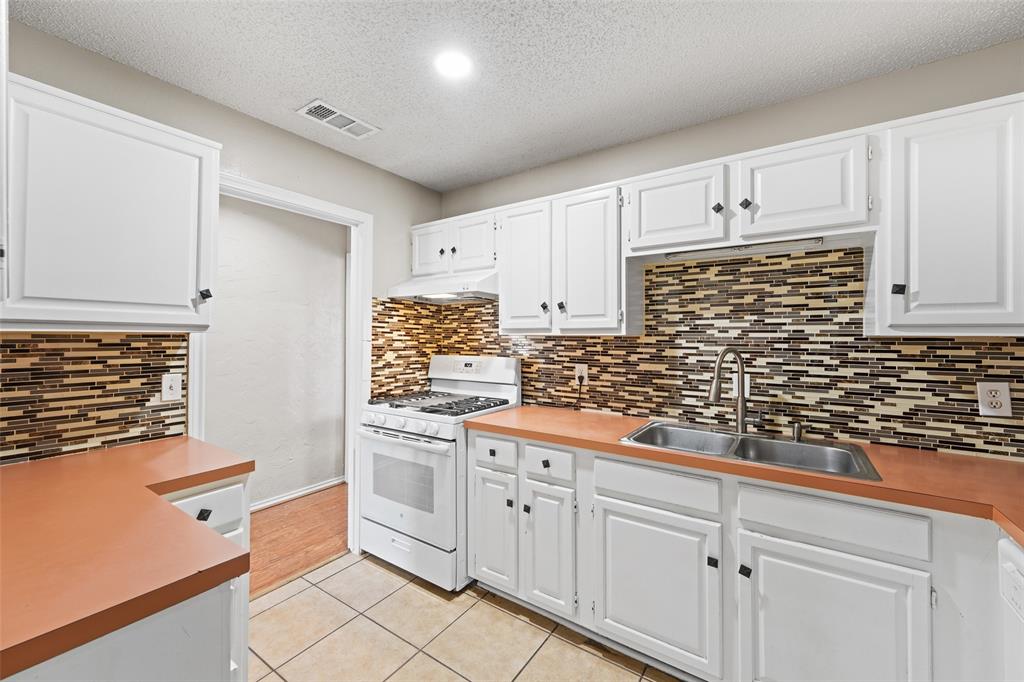 708 Azalea Drive Forney, TX 75126 - Photo 9 of 18 a kitchen with white cabinets and white appliances