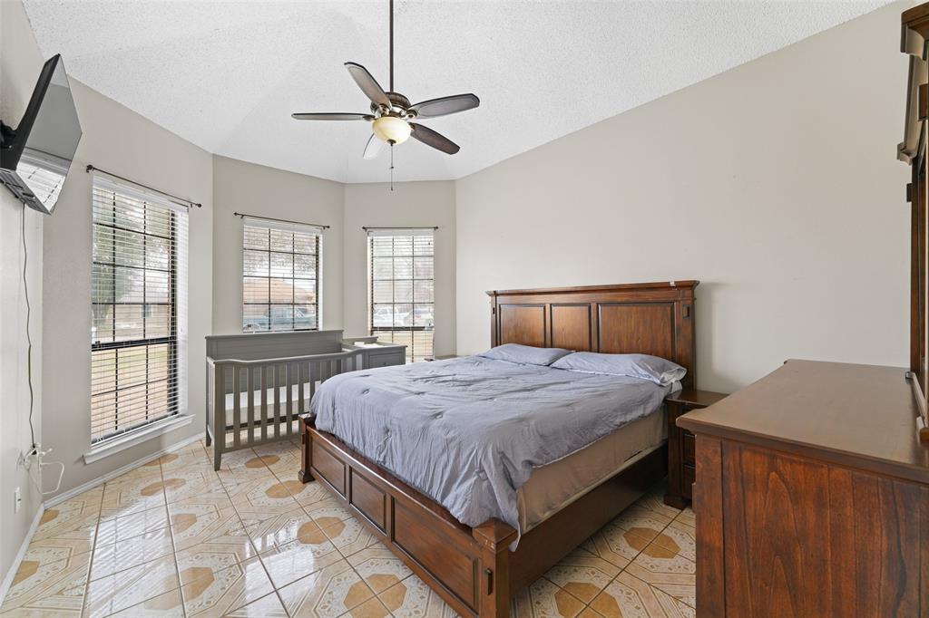 708 Azalea Drive Forney, TX 75126 - Photo 10 of 18 a bedroom with a bed and window