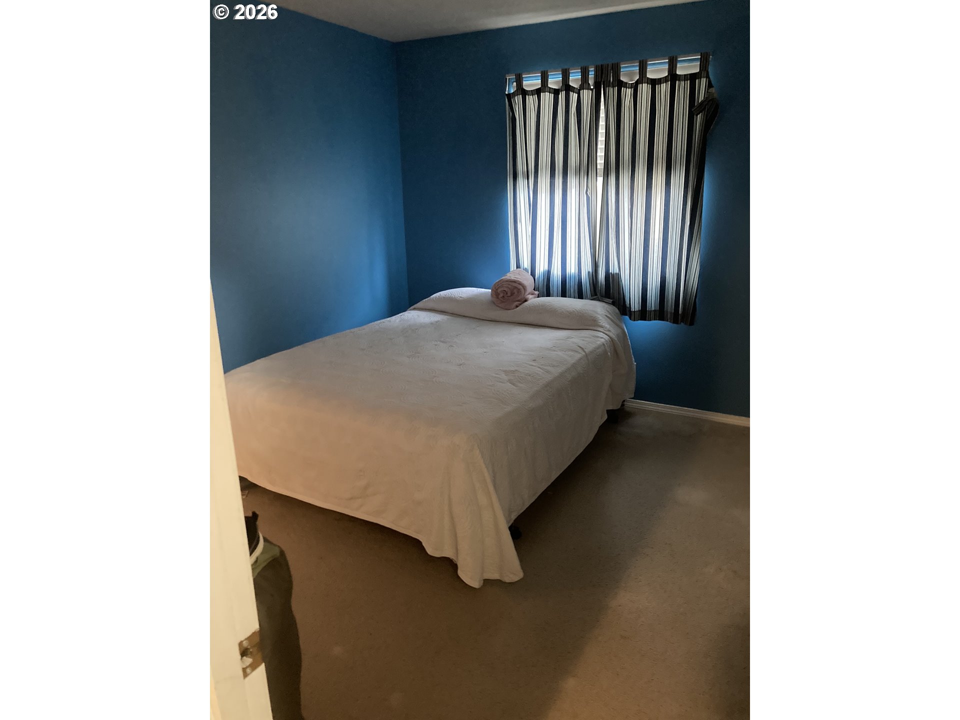 2499 North Holladay Street Cornelius, OR 97113 - Photo 19 of 26 a bed sitting in a bedroom next to a window