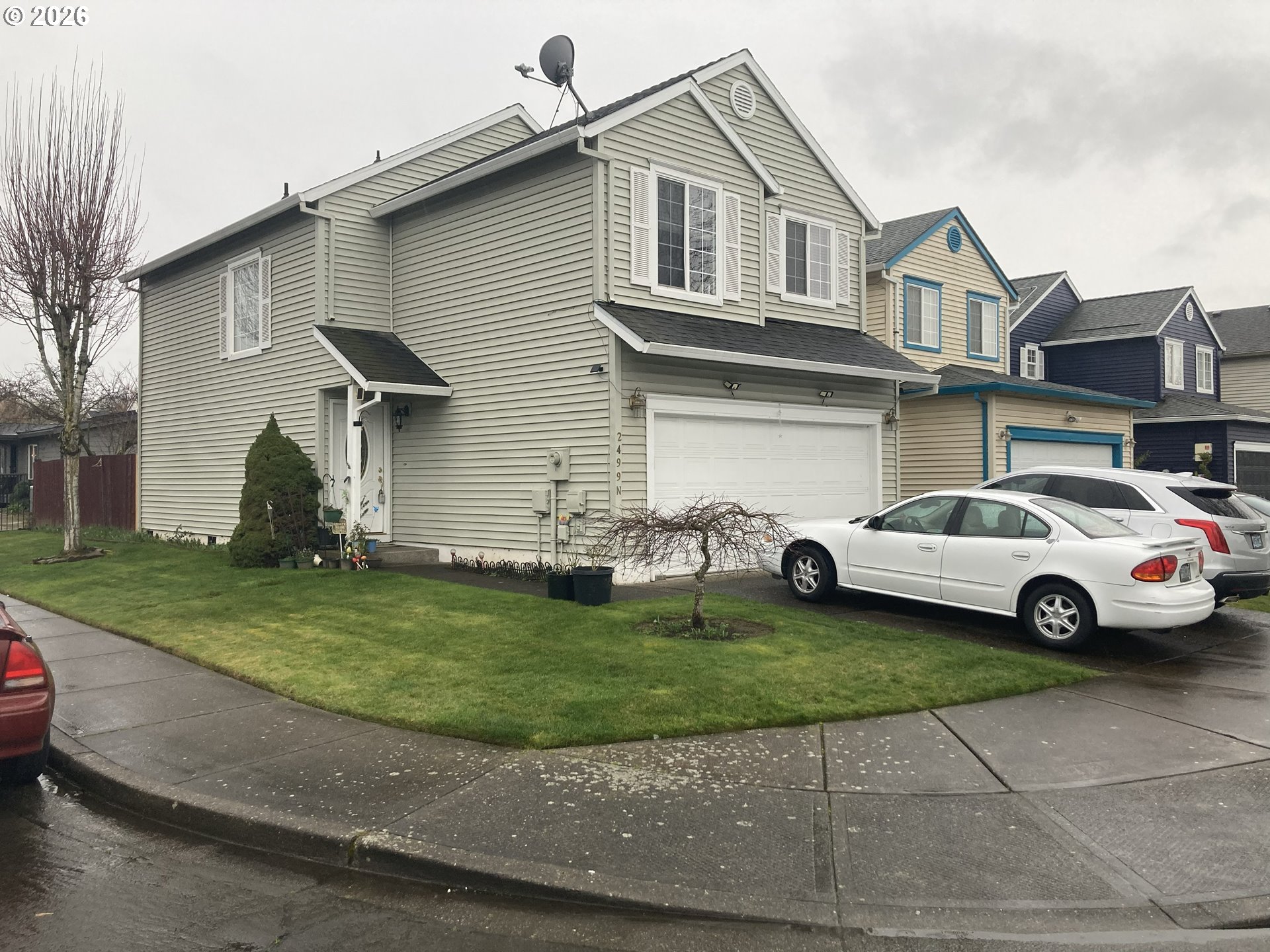 2499 North Holladay Street Cornelius, OR 97113 - Photo 2 of 26 a white house sitting in the middle of a yard