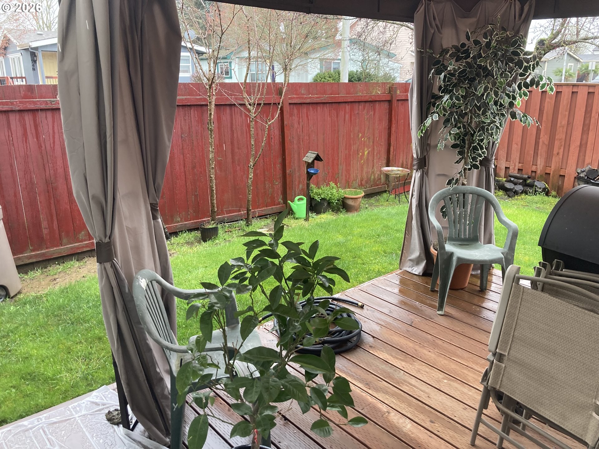 2499 North Holladay Street Cornelius, OR 97113 - Photo 25 of 26 a view of a backyard with chairs potted plants and wooden fence