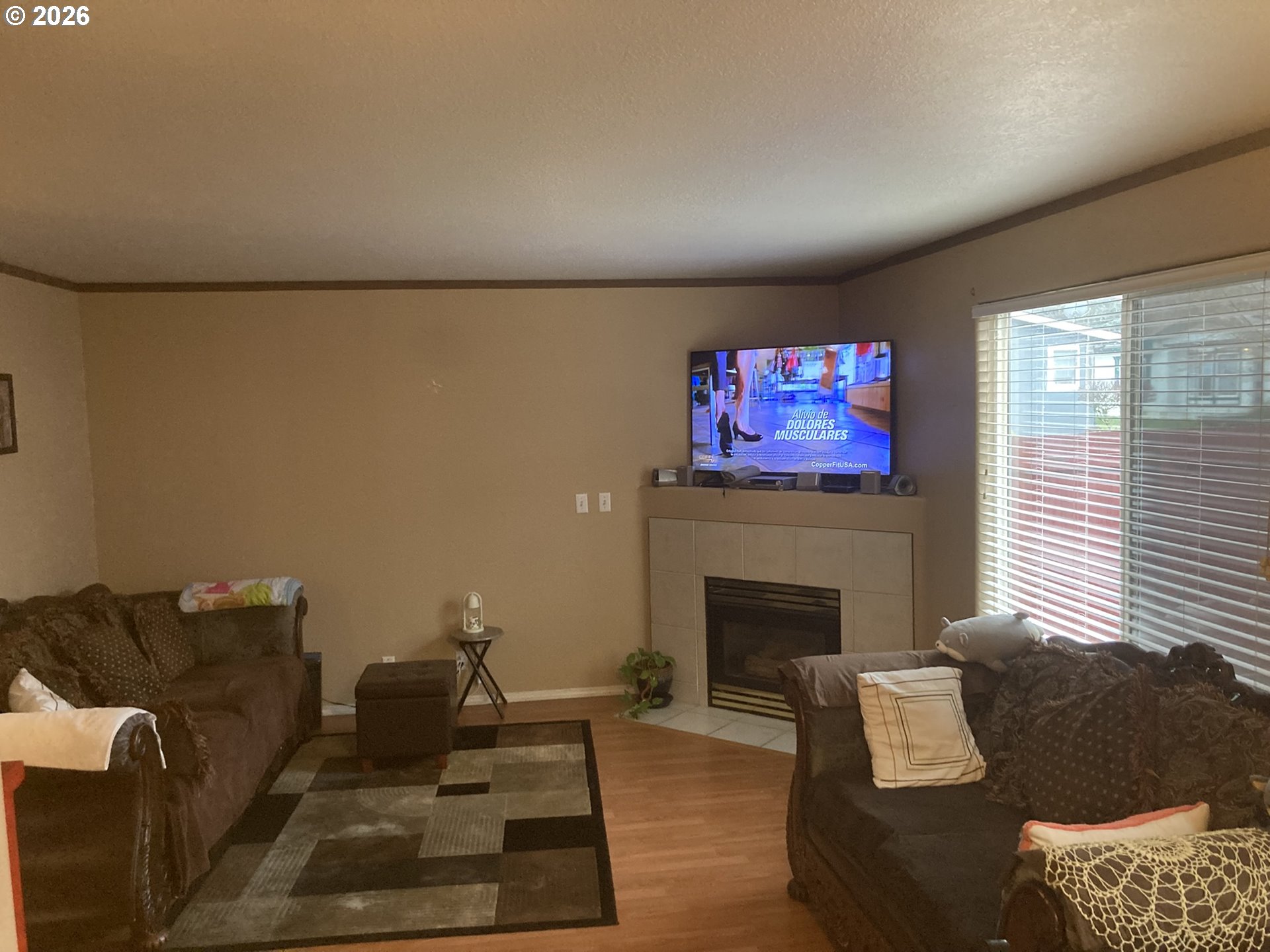 2499 North Holladay Street Cornelius, OR 97113 - Photo 6 of 26 a living room with furniture a flat screen tv and a fireplace