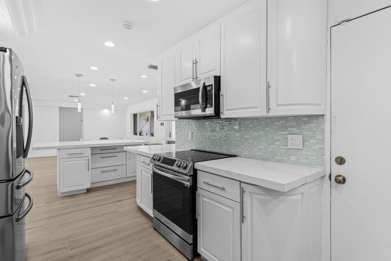 2611 Northeast 49th Street Lighthouse Point, FL 33064 - Photo 14 of 56 kitchen & garage entry
