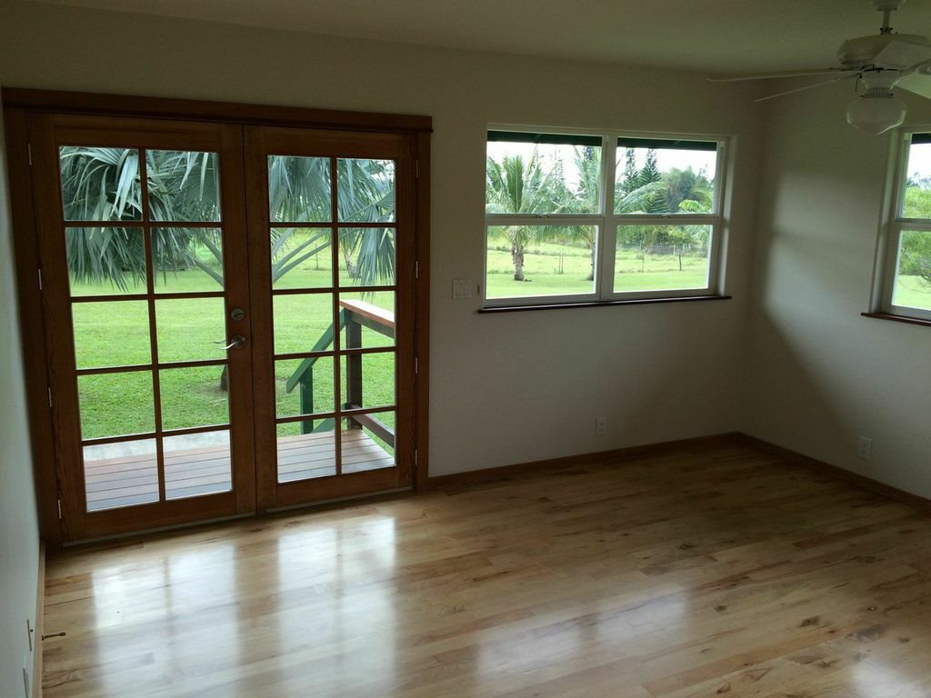 851 Peahi Road Haiku, HI 96708 - Photo 13 of 30 an empty room with wooden floor and windows