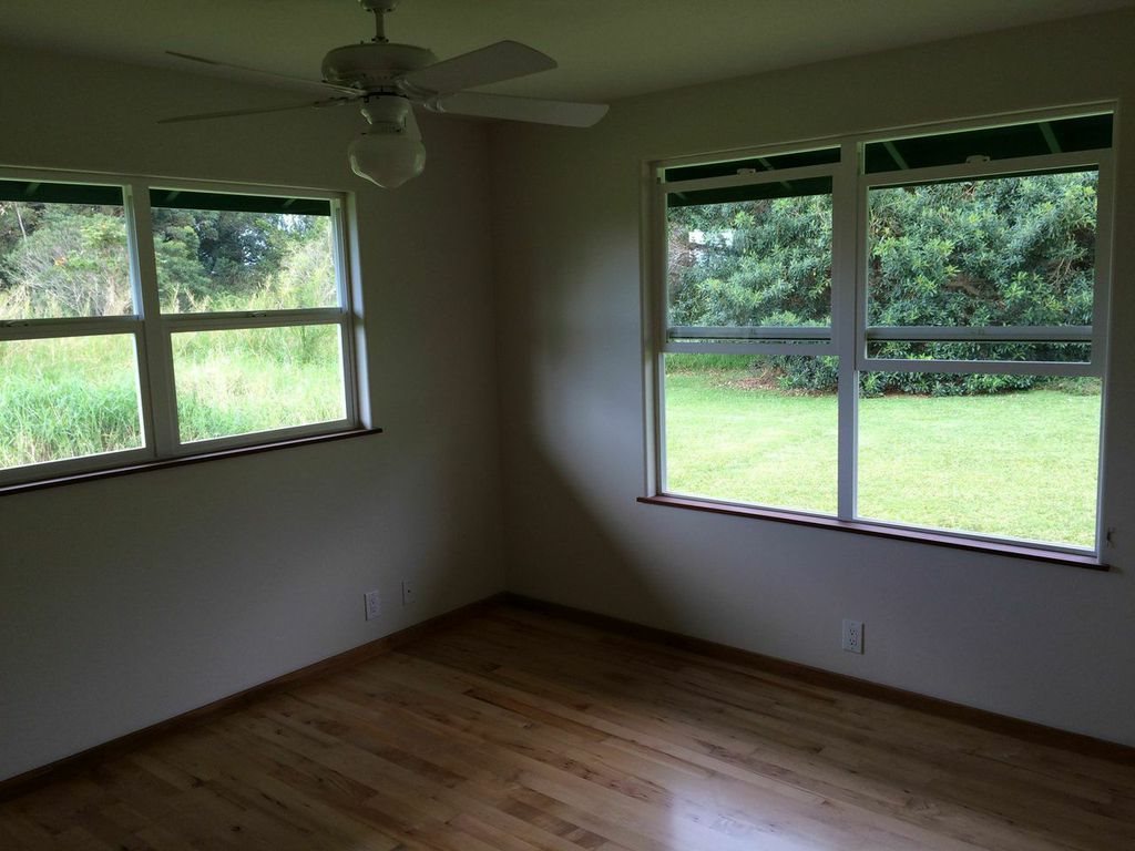 851 Peahi Road Haiku, HI 96708 - Photo 14 of 30 a view of an empty room with wooden floor and a window