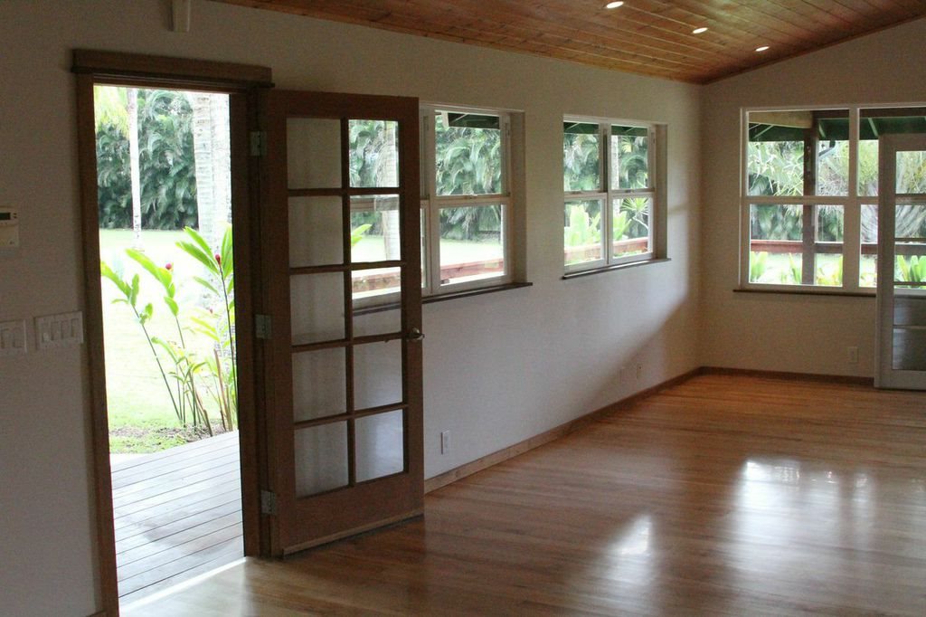 851 Peahi Road Haiku, HI 96708 - Photo 17 of 30 an empty room with wooden floor and windows