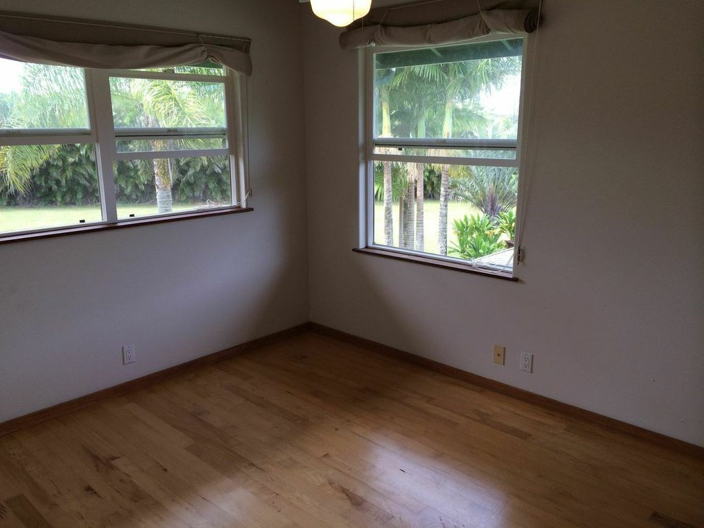 851 Peahi Road Haiku, HI 96708 - Photo 19 of 30 an empty room with wooden floor and a window
