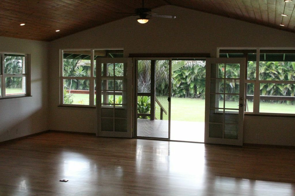851 Peahi Road Haiku, HI 96708 - Photo 22 of 30 a view of an empty room with wooden floor and a window