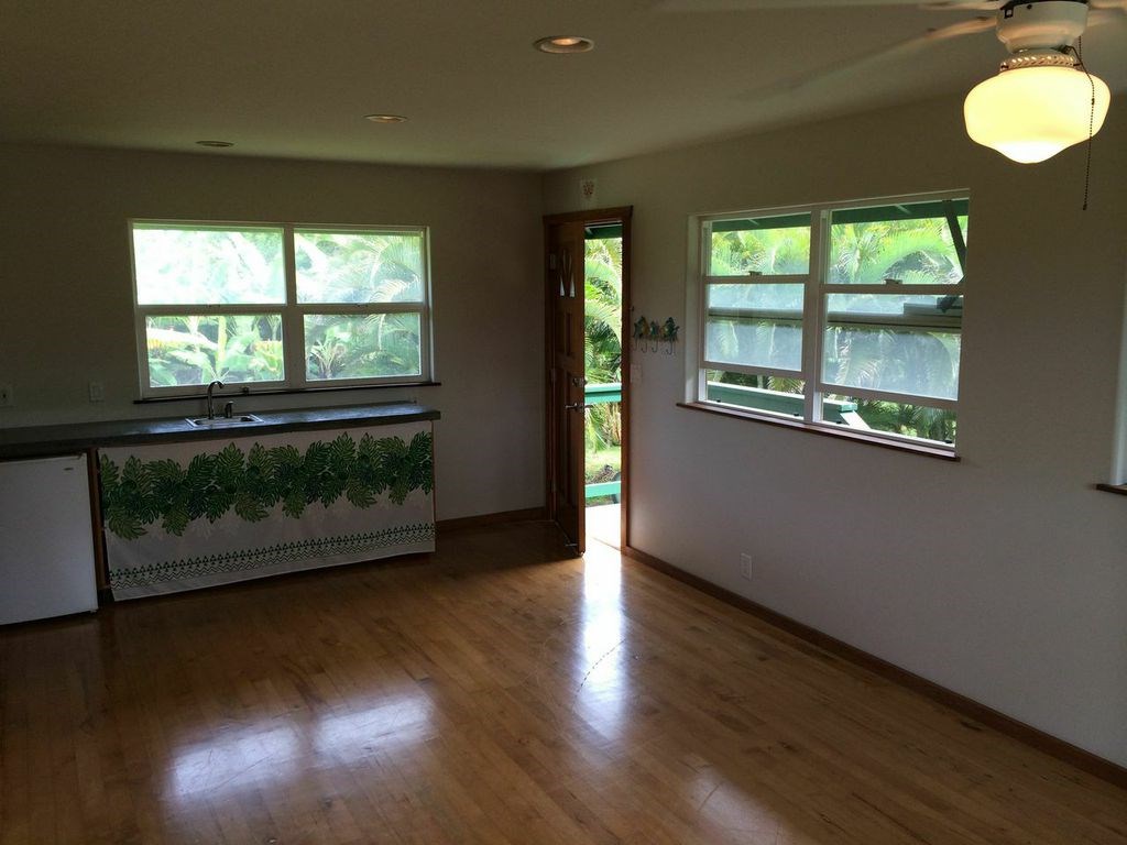 851 Peahi Road Haiku, HI 96708 - Photo 25 of 30 an empty room with wooden floor and windows